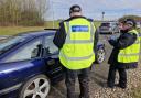 Officers speaking to a driver at a checkpoint