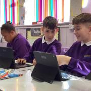 School pupils enjoying the new tablets