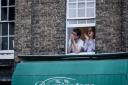 A couple lean from their flat window above Dorringtons in Saffron Walden to clap for the key workers. Picture: CELIA BARTLETT PHOTOGRAPHY