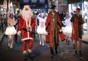 Santa, Saffron Walden Mayor Richard Porch and Santa's chief elf make their way to the Market Place to switch on the lights