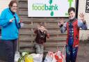 Beaver Leader Jenny Dear with Jasper (Cub) and Seb (Scout) and donated items from Trick or Eat for Uttlesford Foodbank