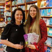 Author TA Rosewood (left) at the Hart's Books event in Saffron Walden with Sophie, holding the author's books