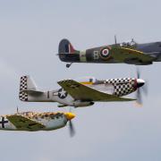 Spitfire MH434, Mustang TF51 'Contrary Mary' and a Hispano Bouchon in flight over IWM Duxford.