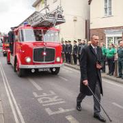Fire and ambulance service personnel, and the public, line the route to pay respects to the late David Curtis in Saffron Walden
