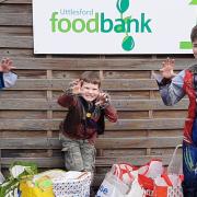 Beaver Leader Jenny Dear with Jasper (Cub) and Seb (Scout) and donated items from Trick or Eat for Uttlesford Foodbank