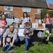 Lana (right), 10, with egg hunt attendees and raffle prizes