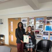 Kemi Badenoch delivering the award to India at Saffron Walden County High