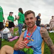 Jack Forster with his medal at the end of his run