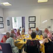 Service users and volunteers enjoying a catch up at Saffron Walden's Forget Me Not Dementia Café