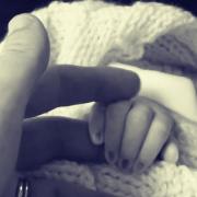 Clare holding her niece Eloise's hand