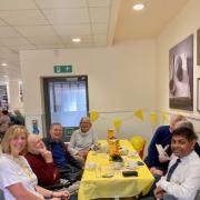 Visitors to the 'chatter and natter' table with host Suzanne Andrews and store manager OJ Daya.