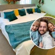 Alex Dodman and his family with the huge bed he built for them all